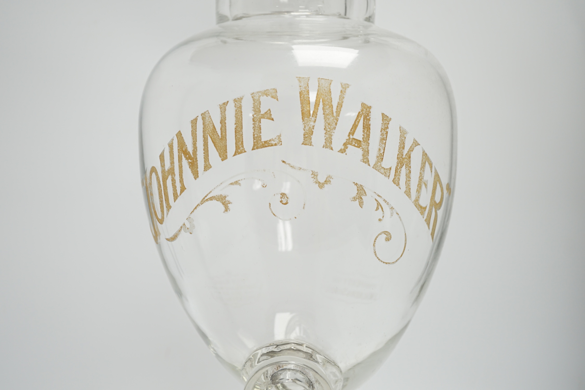 A Johnnie Walker glass advertising shop display whisky urn and cover, 65cm high. Condition - poor